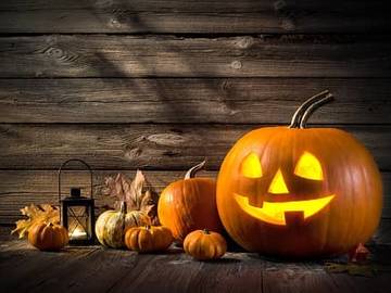 jack o lantern and several small pumpkins
